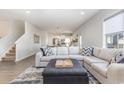 Open concept living room with sectional sofa, offering a view into the kitchen area at 3519 Cornflower Way, Conway, SC 29526