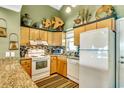 Bright kitchen boasts granite countertops and stainless steel appliances at 551 S Waccamaw Dr., Garden City Beach, SC 29576