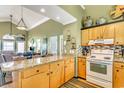 Open kitchen with granite island and views into the living area at 551 S Waccamaw Dr., Garden City Beach, SC 29576