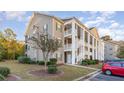 Two-story building with columns, balconies, and landscaping at 5810 Longwood Dr. # 201, Murrells Inlet, SC 29576