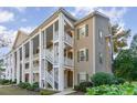 Two-story building with columns, balconies, and landscaping at 5810 Longwood Dr. # 201, Murrells Inlet, SC 29576