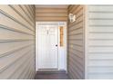 White front door with sidelight, located in building exterior at 5810 Longwood Dr. # 201, Murrells Inlet, SC 29576