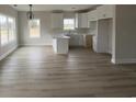 Modern kitchen with white cabinets, quartz countertops, and stainless steel appliances at 3854 Red Bluff Rd., Loris, SC 29569