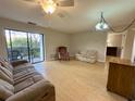 Living room with couch, chair, and access to balcony at 5001 Little River Rd. # E115, Myrtle Beach, SC 29577