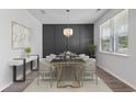 Elegant dining room features a dark-gray wall and modern furniture at 878 Snowberry Dr., Longs, SC 29568