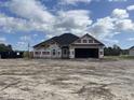 New construction home features gray vinyl siding, a black roof and a two-car garage at 487 Highway 348, Loris, SC 29569