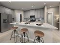 Modern kitchen with island and light gray cabinets at 1213 Glenrose Ct Nw, Calabash, NC 28467