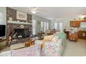 Open living room and kitchen with brick fireplace at 206 56Th Ave. N, North Myrtle Beach, SC 29582