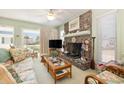 Cozy living room with fireplace, TV, and floral sofa at 206 56Th Ave. N, North Myrtle Beach, SC 29582