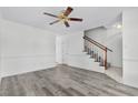 Bright living room featuring laminate floors and staircase at 2925 Carriage Row Ln. # 134, Myrtle Beach, SC 29577
