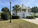 Two-story house with double garage, front porch, and landscaping at 101 Georges Bay Rd., Surfside Beach, SC 29575