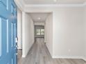 Light and bright entryway with blue door and gray vinyl flooring at 680 Blackthorne Circle Nw, Calabash, NC 28467