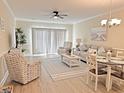 Living room with seating, dining area, and sliding doors at 110 South Shore Blvd. # 103, Longs, SC 29568