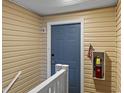 Hallway with a blue door and fire extinguisher at 8546 Hopkins Circle # G, Surfside Beach, SC 29575