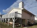 House exterior showcasing a deck, raised foundation, and partial view of the backyard at 848 S Waccamaw Dr., Garden City Beach, SC 29576