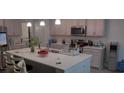 Modern kitchen with white cabinets, island, and stainless steel appliances at 2808 Stellar Loop, Myrtle Beach, SC 29577