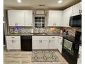 Modern kitchen with white cabinets, granite counters, and black appliances at 276 Palmetto Glen Dr., Myrtle Beach, SC 29588