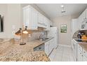 Modern kitchen with granite counters and white cabinets at 1025 Algonquin Dr. # 15-E, Pawleys Island, SC 29585