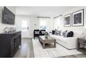 Open concept living room with white couch and dark wood furniture at 2764 Rowyn St., Longs, SC 29568