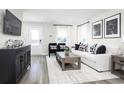 Living room with white couch, black accent chairs, and a large area rug at 2752 Rowyn St., Longs, SC 29568