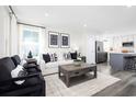 Open living room with white sofa, black chairs, and a coffee table at 2740 Rowyn St., Longs, SC 29568