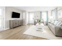 Bright living room with gray sofa and white coffee table at 2760 Rowyn St., Longs, SC 29568