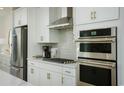 Modern kitchen with stainless steel appliances and white cabinets at 8481 Duke Pl. # 35, Myrtle Beach, SC 29572