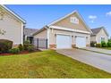 Two-story tan home with a two-car garage and neat landscaping at 1562 Palmina Loop # B, Myrtle Beach, SC 29588