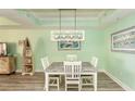 Bright dining room with a square table and four chairs, coastal decor at 100 North Beach Blvd. # 311, North Myrtle Beach, SC 29582