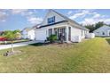 Newly built home with gray siding, landscaped lawn, and a covered porch at 294 Portofino Dr., Myrtle Beach, SC 29579