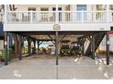 Covered parking area under the house with golf carts at 6001 - N120 S Kings Hwy., Myrtle Beach, SC 29575