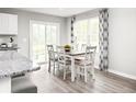 Kitchen dining area with four chairs and sliding glass door at 3006 Nw Edgemead Circle # B, Calabash, NC 28467