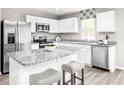 Modern kitchen with white cabinets, granite countertops, and stainless steel appliances at 3006 Nw Edgemead Circle # B, Calabash, NC 28467