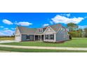 New home exterior with gray siding, double garage and landscaped yard at 550 Wagon Wheel Trail, Calabash, NC 28467