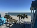 Stunning ocean view from a balcony, with beach access and palm trees at 700 N Waccamaw Dr. # 319, Garden City Beach, SC 29576