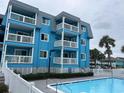 Inviting blue swimming pool with a white fence and surrounding buildings at 700 N Waccamaw Dr. # 319, Garden City Beach, SC 29576