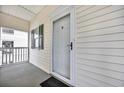 Private condo entry with exterior door, balcony, and green shutters at 612 River Oaks Dr. # 55D, Myrtle Beach, SC 29579
