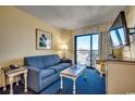 Bright living room with ocean view and comfy seating at 7100 Ocean Blvd. N # 825, Myrtle Beach, SC 29572