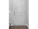 White front door with two panels and brushed nickel hardware at 420 Ribbon Rail Way, Loris, SC 29569