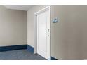 White condo entry door with number 128 at 300 N Ocean Blvd. # 128, North Myrtle Beach, SC 29582