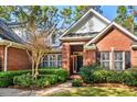 Front view of charming brick home with manicured landscaping at 4491 Horseshoe Bend, Murrells Inlet, SC 29576