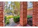 Landscaped front yard view through brick columns at 4491 Horseshoe Bend, Murrells Inlet, SC 29576