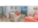 Bright living room with coral sofas and coastal decor at 6001 - 8016 S Kings Hwy., Myrtle Beach, SC 29575