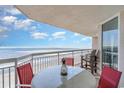 Oceanfront balcony with table and chairs, offering stunning ocean views at 1625 S Ocean Blvd. # 1002, North Myrtle Beach, SC 29582
