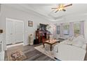 Living room with hardwood floors, sofa, and TV at 131 Grissett Lake Dr., Conway, SC 29526