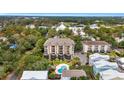 Aerial view of condo building with pool, close to other homes and businesses at 310 73Rd Ave. N # 5-C, Myrtle Beach, SC 29572