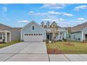 Two-story light blue house with a large gray garage door at 7274 Sarteano Dr., Myrtle Beach, SC 29572