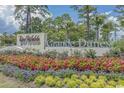 Grande Dunes community entrance with a welcoming sign and landscaping at 7274 Sarteano Dr., Myrtle Beach, SC 29572