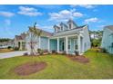 Light blue house exterior with a front porch and landscaping at 7274 Sarteano Dr., Myrtle Beach, SC 29572
