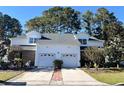 Brick front townhouse with two-car garage and landscaping at 493 Shellbank Dr. # 2-B, Longs, SC 29568